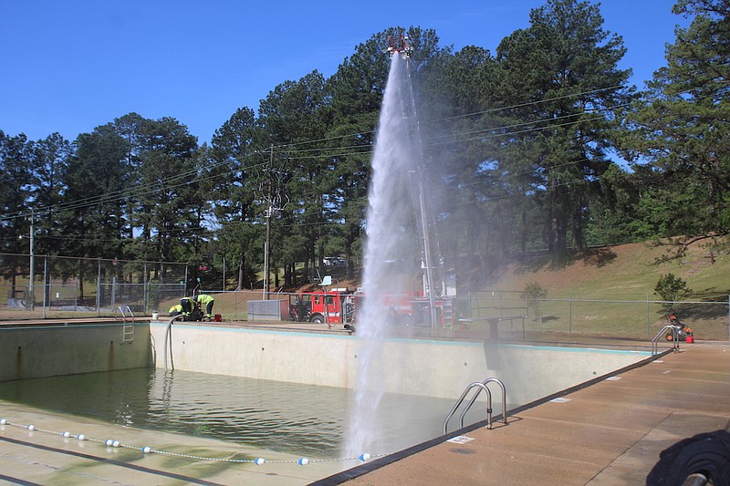 Photo By: Michael Hanich
 The Camden Fire Department cleans the pool at Carnes Park on Wednesday, May 3.