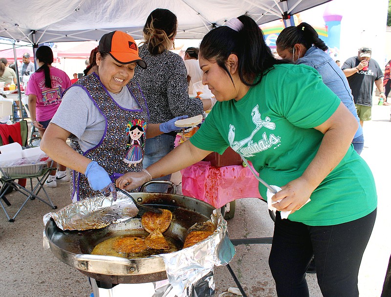Remedios Acosta, left, and Fabiola Soria prepare tortillas for making enchiladas Sunday afternoon, May 28, 2023, at Vero's Latino Store in Texarkana, Texas. The women were one of about 15 vendors participating in a fundraiser for Ruben Olalde and Aida Garcia, their daughter Lisbet and son Oliver. The family were killed Tuesday, May 23 at their home in Nash, Texas. (Staff photo by Stevon Gamble)