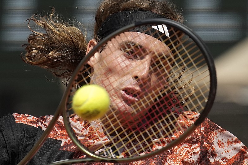 Greece's Stefanos Tsitsipas plays a shot against Jiri Vesely of the Czech Republic during their first round match of the French Open tennis tournament at the Roland Garros stadium in Paris, Sunday, May 28, 2023. (AP Photo/Christophe Ena)