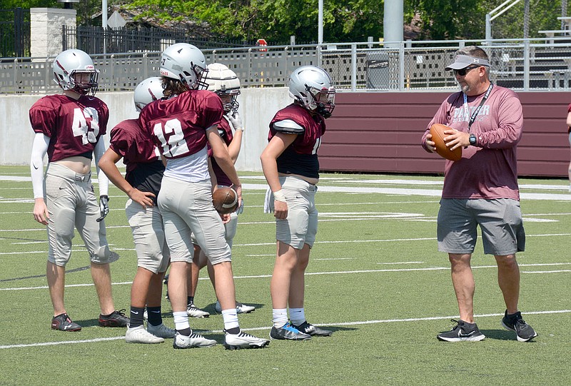 Graham Thomas/Herald-Leader
Siloam Springs football coach Brandon Craig (right) works with offensive backs during spring practice earlier this month. The Panthers wrapped up spring practice last week and will start their summer program Monday.