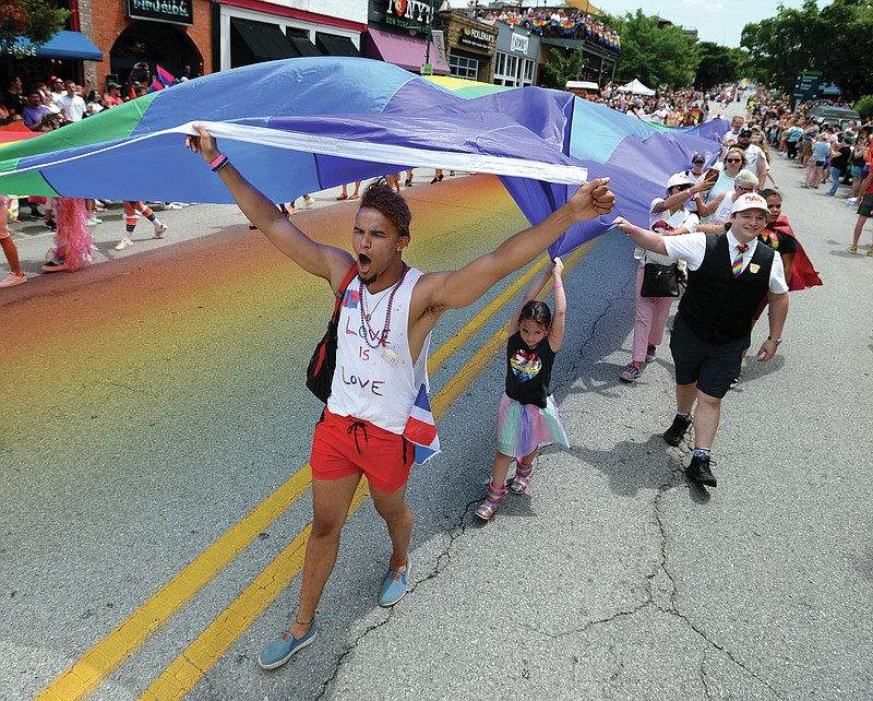 Starling Terrero (left) of Fayetteville celebrates during a previous Pride Parade on Dickson Street. (NWA Democrat-Gazette File Photo/Andy Shupe)