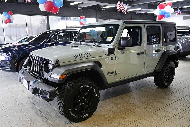 A plug-in hybrid gas/electric Jeep Wrangler is displayed on the showroom floor at the Dan O'Brien Auto Group dealership, Monday, Feb. 27, 2023, in Methuen, Mass. Leasing is starting to look like the cheapest way to get an electric or hybrid vehicle because the U.S. government is giving them a big advantage. Dealers can apply up to the full $7,500 U.S. tax credit to leases of all electric vehicles and some plug-in hybrids regardless of where they're made.(AP Photo/Charles Krupa)