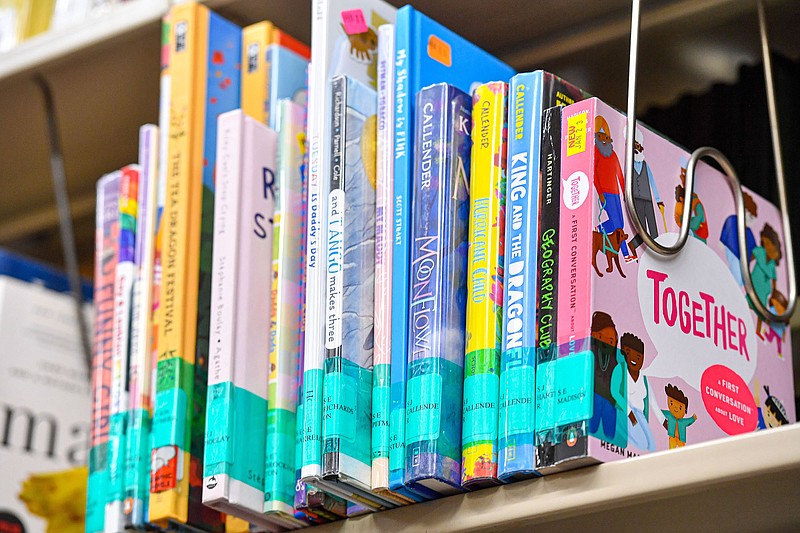 A selection of childrens books which have been under scrutiny from community members are displayed in a designated section, Thursday, May 11, 2023, at the Alma Public Library in Alma. (River Valley Democrat-Gazette/Hank Layton)