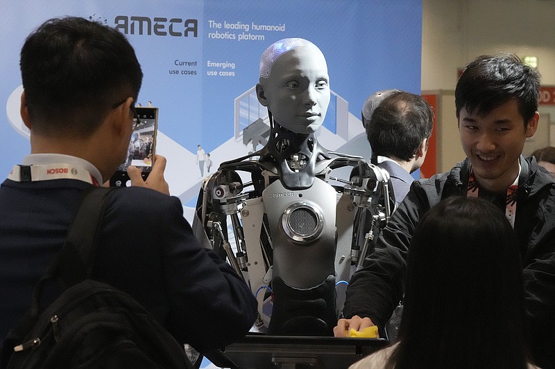 A robot designed by Engineers Arts and called AMECA, interacts with visitors May 30 during the International Conference on Robotics and Automation ICRA in London. (AP/Frank Augstein)