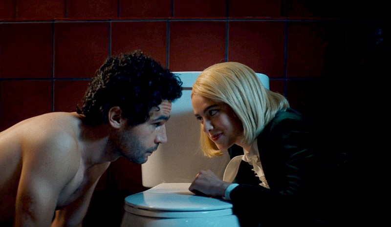 Christopher Abbott, left, and Margaret Qualley in "Sanctuary." MUST CREDIT: Neon
