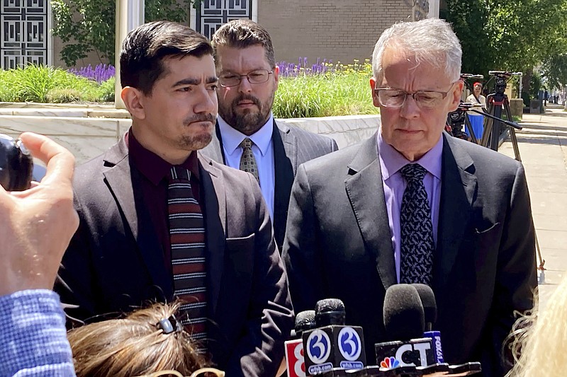 Michael DiMassa, left, and his lawyer, John Gulash, right, speak to reporters outside federal court in Hartford, Conn., Wednesday, May 31, 2023. DiMassa was sentenced to more than two years in prison for stealing $1.2 million from the city of West Haven, Conn. (AP Photo/Dave Collins)