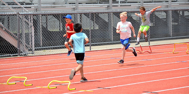 Annette Beard/Pea Ridge TIMES
First- through sixth-grade students learned basics of track this past week at the Lil Hawks Track Camp held at the indoor facility and on the track and football field.