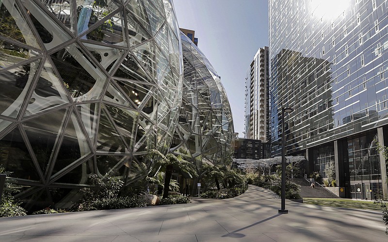 FILE - The exterior of the Amazon headquarters is shown in Seattle Friday, March 20, 2020. A group of Amazon workers upset about recent layoffs, a return-to-office mandate and the company's environmental impact is planning a walkout at its Seattle headquarters Wednesday. (AP Photo/Elaine Thompson, File)
