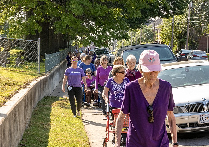 Josh Cobb/News Tribune. Independent living and memory care residents from Heisinger Bluffs participated in a brain awareness walk at Heisinger Bluffs on Thursday morning. The walk was held in celebration of Alzheimers and brain awareness month.