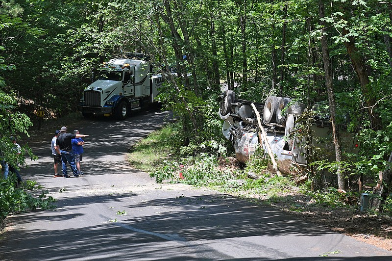 A fuel tanker truck is seen on its side off the road in the 300 block of Camp Yorktown Lane after it reportedly wrecked shortly before 10:30 a.m. Thursday. - Photo by Lance Porter of The Sentinel-Record