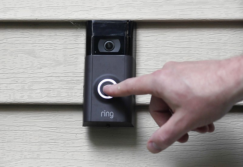 FILE - Ernie Field pushes the doorbell on his Ring doorbell camera, July 16, 2019, at his home in Wolcott, Conn. In a vote Wednesday, May 31, 2023, the Federal Trade Commission is ordering Amazon to pay more than $30 million in fines over privacy violations involving its voice assistant Alexa and its doorbell camera Ring. (AP Photo/Jessica Hill, File)