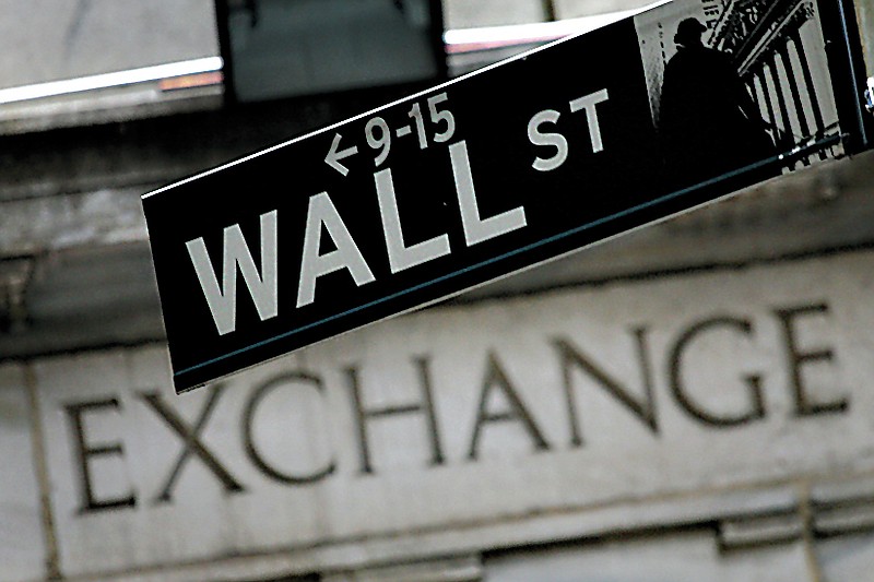 A Wall St. sign hangs in front of the New York Stock Exchange Tuesday, Sept. 30, 2008, in New York.(AP Photo/Mark Lennihan)