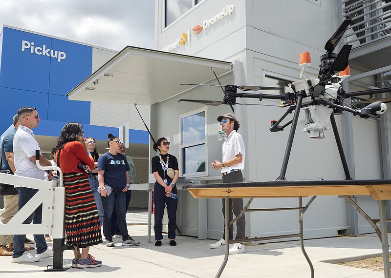 Flight Engineer Carter Firquain (center) shows visitors the DroneUp delivery system, Thursday, June 1, 2023 during a tour outside of Walmarts Market Fulfillment Center in Bentonville. Walmart opened its first Market Fulfillment Center in Arkansas at Store 100 located at 406 S Walton Blvd in Bentonville on Monday, underlining the retailers move toward expanding the use of its stores as fulfillment centers. Visit nwaonline.com/photos for today's photo gallery.

(NWA Democrat-Gazette/Charlie Kaijo)