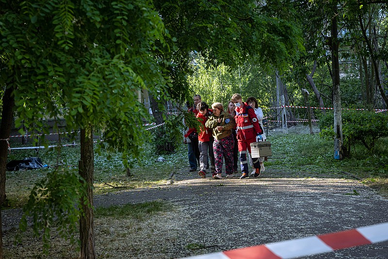 A woman is led away by emergency workers after she identified the body of her daughter, who was killed in an overnight airstrike on Kyiv, Ukraine, on Thursday, June 1, 2023. Russia targeted the Ukrainian capital yet again with a missile attack in the early hours of Thursday, killing three people, including a mother and child who were not able to get into a shelter, officials said. (Nicole Tung/The New York Times)