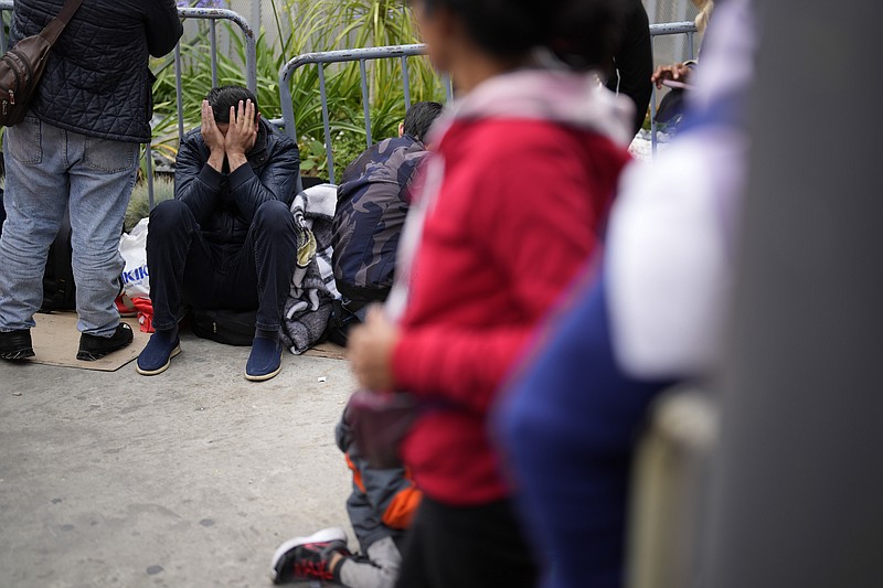 People waiting to apply for asylum camp near the pedestrian entrance to the San Isidro Port of Entry, linking Tijuana, Mexico with San Diego, Thursday, June 1, 2023, in Tijuana, Mexico. U.S. authorities raised the number of people allowed to enter the country with an online app allows asylum-seekers to enter the country with appointments to 1,250 a day from 1,000 though demand still far outstrips supply. (AP Photo/Gregory Bull)