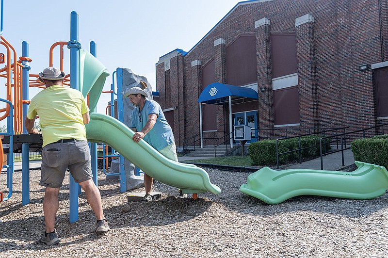 Jeff Croft, (from right) and Brandon Croft work to replace a slide at the Rogers Boys and Girls club Friday June 2, 2023, in Rogers. The club had is grand reopening Friday after a having a $300,000 dollar renevation. 
(NWA Democrat-Gazette/Spencer Tirey)