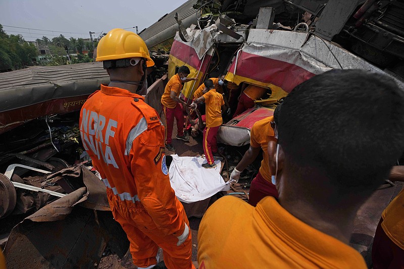 Rescuers carry the body of a victim of a passenger train that derailed in Balasore district, in the eastern Indian state of Orissa, Saturday, June 3, 2023. Rescuers are wading through piles of debris and wreckage to pull out bodies and free people after two passenger trains derailed in India, killing more than 280 people and injuring hundreds as rail cars were flipped over and mangled in one of the countrys deadliest train crashes in decades. (AP Photo/Rafiq Maqbool)