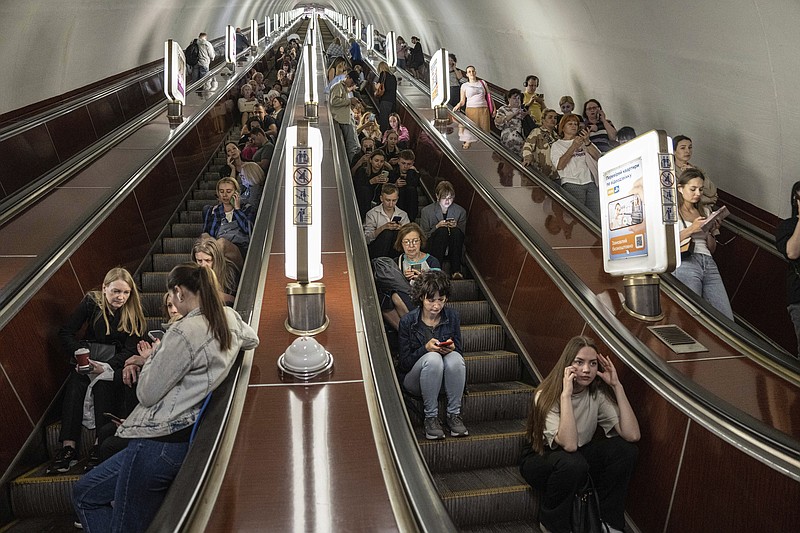 People take cover at a metro station during a Russian rocket attack in Kyiv, Ukraine, Monday, May 29, 2023.  (AP Photo/Evgeniy Maloletka)