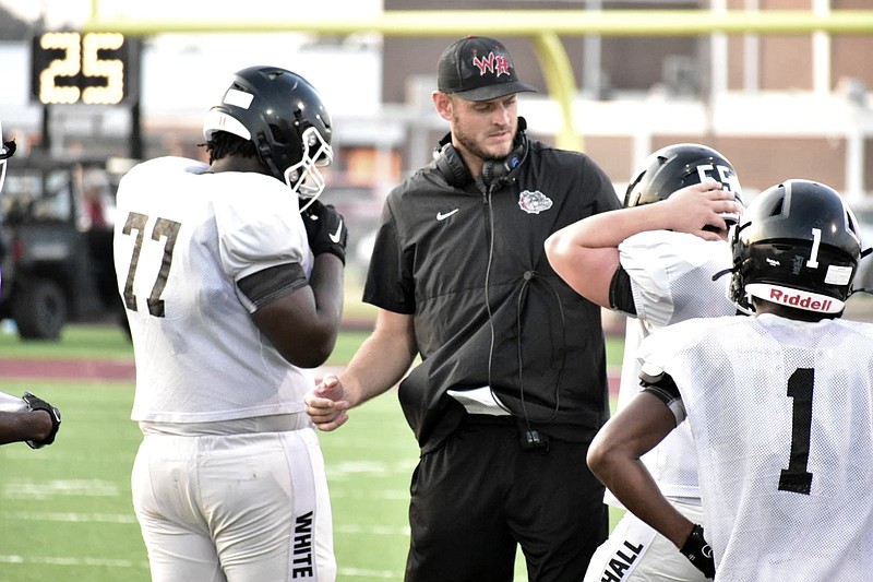 Ryan Mallett, a former Texas High and University of Arkansas standout quarterback and is currently a high school football coach at White Hall, talks with his players in September 2022 during a game. (Photo courtesy of Pine Bluff Commercial)