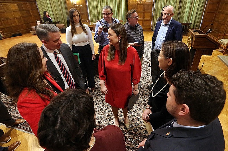 Arkansas Gov. Sarah Huckabee Sanders (center) talks with state legislators after a news conference at the state Capitol in Little Rock in this Feb. 15, 2023 file photo. Sanders had just announced plans to seek federal approval to require ARHOME participants to work, volunteer or enroll in classes. Talking with Sanders are (clockwise from left) state Rep. Lee Johnson, R-Greenwood; Sen. Missy Irvin, R-Mountain View; Rep. Mary Bentley, R-Perryville; and Rep. Aaron Pilkington, R-Knoxville. (Arkansas Democrat-Gazette/Thomas Metthe)