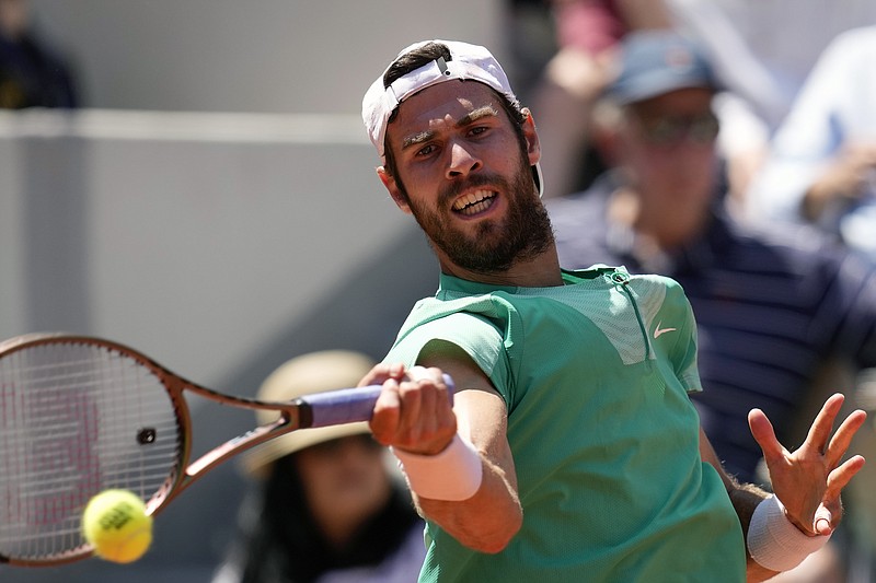 Russia's Karen Khachanov plays a shot against Italy's Lorenzo Sonego during their fourth round match of the French Open tennis tournament at the Roland Garros stadium in Paris, Sunday, June 4, 2023. (AP Photo/Christophe Ena)