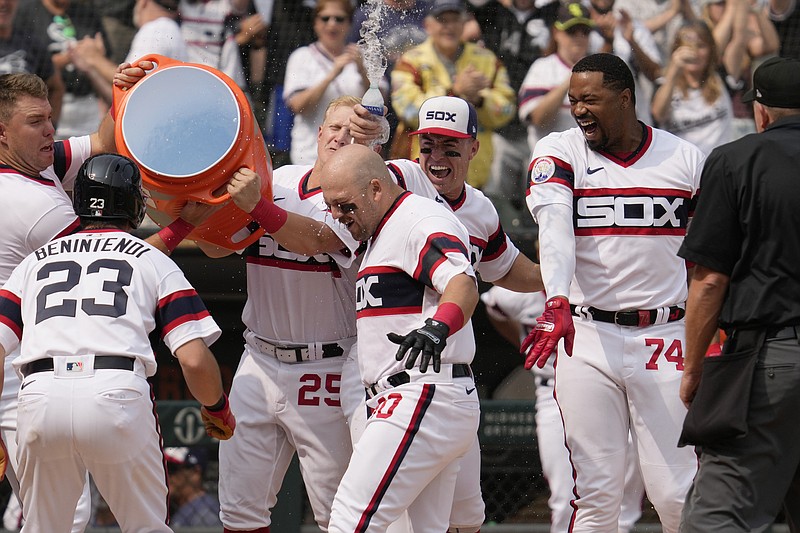 Chicago White Sox's Jake Burger (30), center, is congratulated by teammates after hitting a grand slam during the ninth inning of a baseball game against the Detroit Tigers in Chicago, Sunday, June 4, 2023. (AP Photo/Nam Y. Huh)