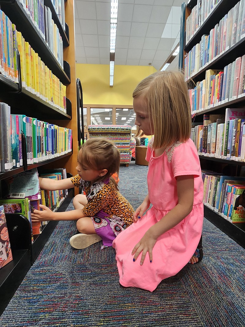 Scout Baber, right, and Alice Allen pick books at the Garland County Library. - Submitted photo