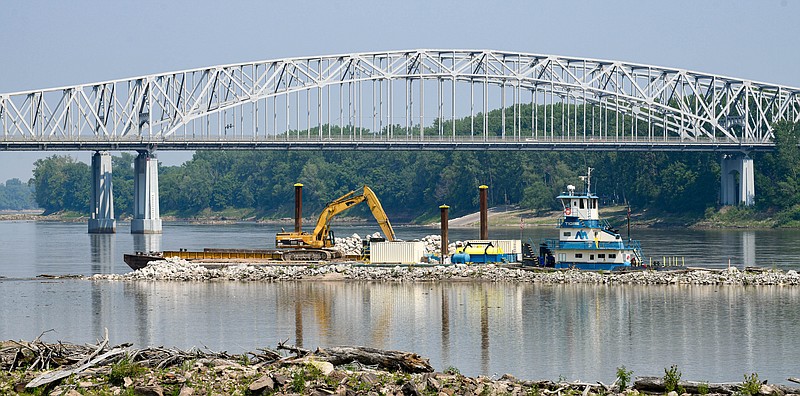Julie Smith/News Tribune
The U.S. Army Corps of Engineers is working to repair wing dikes damaged in the flood of 2019. Currently work in underway to buttress the water diversions just east of the U.S. 54/63 bridges over the Missouri River in Jefferson City.  To strengthen the structures,, large rocks are added where necessary.