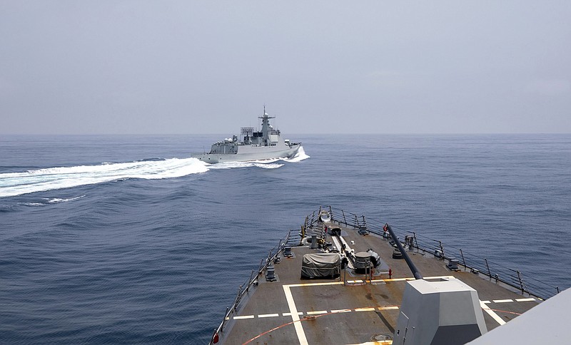 In this photo provided by the U.S. Navy, the USS Chung-Hoon observes a Chinese navy ship conduct what it called an "unsafe” Chinese maneuver in the Taiwan Strait, Saturday, June 3, 2023, in which the Chinese navy ship cut sharply across the path of the American destroyer, forcing the U.S. ship to slow to avoid a collision. The incident occurred as the American destroyer and Canadian frigate HMCS Montreal were conducting a so-called “freedom of navigation” transit of the strait between Taiwan and mainland China.  (Mass Communication Specialist 1st Class Andre T. Richard/U.S. Navy via AP)