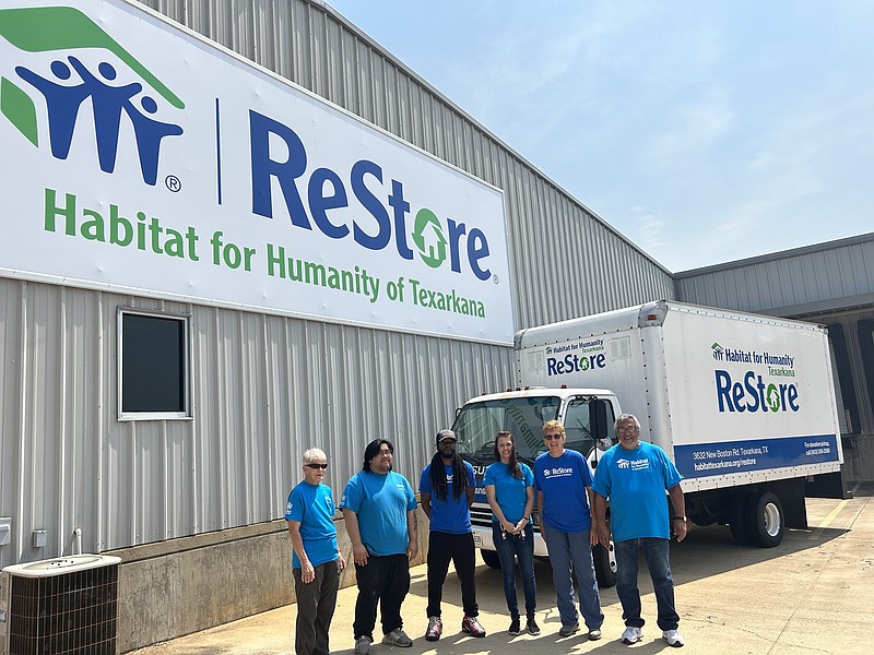 Judy Head, from left, Phat Nguyen, Shaun Richards, Donna Williamson, Katherine Morgan and Eugene Flores stand in front of Habitat for Humanity ReStore's new sign, thanks to a donation from the Patterson-Troike Foundation, on Tuesday, June 6, 2023, in Texarkana, Texas. (Staff photo by Sharda James)