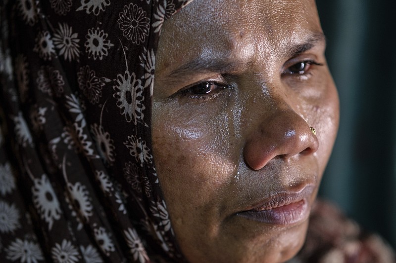 Bulbul, a Rohingya refugee and the sister of the missing boats captain, Jamal Hussein, cries as she shares memories of her brother during an interview at her shelter in a Rohingya refugee camp in the Cox's Bazar district of Bangladesh, on March 5, 2023. (AP Photo/Mahmud Hossain Opu)