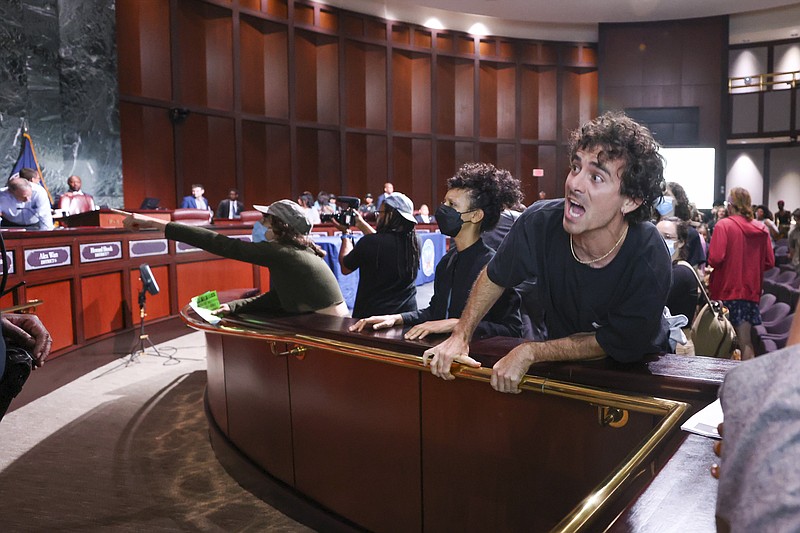 Protesters yell at council members after the vote passed 11 to 4 to approve legislation to fund a police and firefighter training center, Tuesday, June 6, 2023, in Atlanta. (Jason Getz/Atlanta Journal-Constitution via AP)