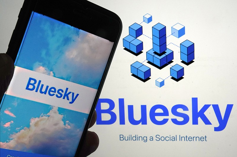 The app for Bluesky is shown on a mobile phone, left, and on a laptop screen, in New York, Friday, June 2, 2023. Bluesky, the internet's hottest members-only spot at the moment, does feel a bit like an exclusive club, populated by some Very Online folks, popular Twitter characters as well as fed up ex-users of the Elon Musk-owned platform. (AP Photo/Richard Drew)