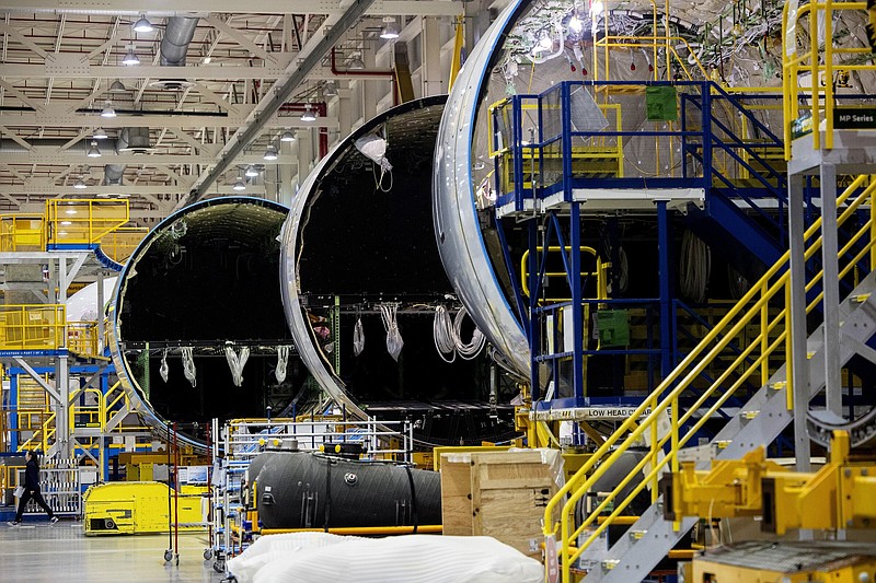 An employee walks past a fuselage section under construction at Boeing Co.'s 787 Dreamliner campus in North Charleston, S.C. on Tuesday, May 30, 2023. (Gavin McIntyre/The Post And Courier via AP, Pool)