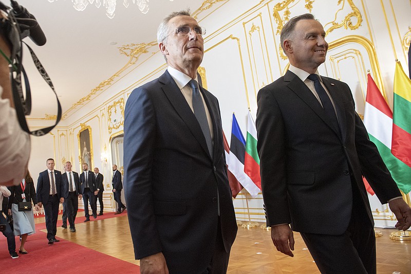 NATO Secretary General Jens Stoltenberg, left, and Polish President Andrzej Duda, right, arrive at the meeting of the leaders of the Bucharest Nine, a group of nine countries that make up the eastern flank of NATO, in Bratislava, Slovakia, Tuesday, June, 6, 2023. (Michal Svitok/TASR via AP)