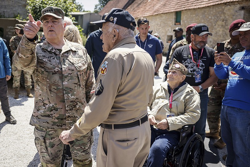 U.S. Gen. Mark Milley, left, meets veterans during a gathering in preparation for the 79th D-Day anniversary in La Fiere, Normandy, France, Sunday, June 4, 2023. The landings on the coast of Normandy 79 year ago by U.S. and British troops took place on June 6, 1944. (AP Photo/Thomas Padilla)