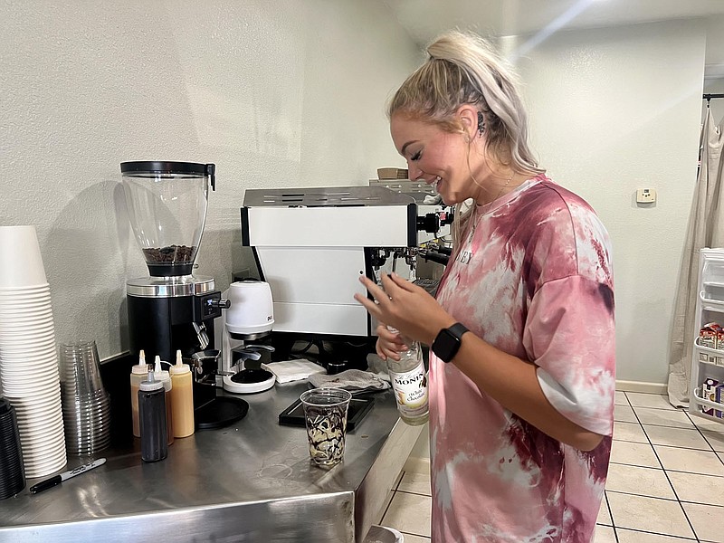 Alexus Underwood/Special to McDonald County Press Lexie Abbott, River Blend Coffee manager, makes a drink at the shop on Harmon Street. Abbott will begin training a new group of students to work at the shop this summer.