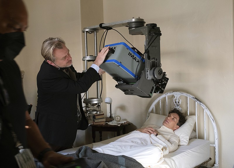 This image released by Universal Picture shows filmmaker Christopher Nolan working with an IMAX camera on the set with actor Cillian Murphy during the filming of "Oppenheimer." (Melinda Sue Gordon/Universal Pictures via AP)