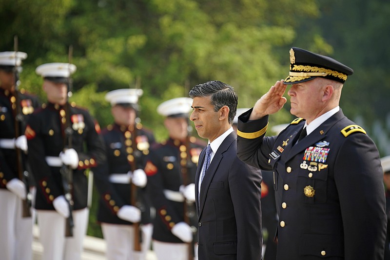 British Prime Minister Rishi Sunak, center left, pays his respects at a wreath at the Tomb of the Unknown Soldier in Arlington National Cemetery during his visit to Washington D.C., Wednesday, June 7, 2023. The war in Ukraine was top Sunak&#x2019;s agenda Wednesday as he started a two-day trip to Washington carrying the message that post-Brexit Britain remains an essential American ally in a world of emboldened authoritarian states.  (Niall Carson/Pool Photo via AP)