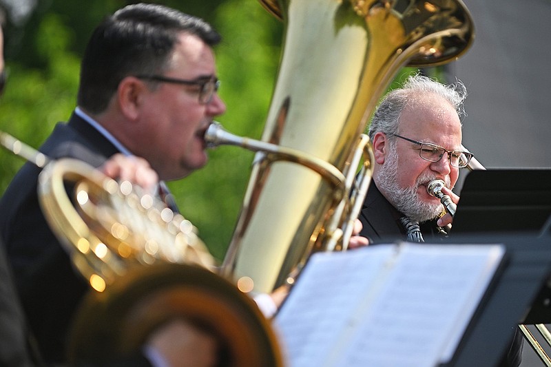 Michael Underwood (right) and Ed Owen, both members of the Arkansas Symphony Orchestra brass quintet, perform during the new music director announcement Wednesday at the future site of the Boyle Smith Music Center in Little Rock.
(Arkansas Democrat-Gazette/Staci Vandagriff)