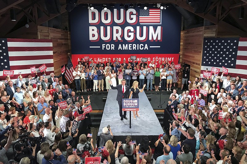 North Dakota Gov. Doug Burgum and first lady Kathryn Burgum, wave to the crowd after he announced his bid for the Republican nomination for President, Wednesday, June 7, 2023, in Fargo, North Dakota.  (AP Photo/Jack Dura)