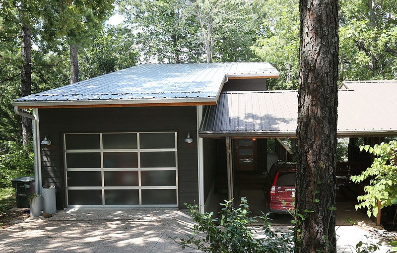 The front of an accessory house rented out as a short-term rental is seen in July 2019 on East Oaks Manor Drive in Fayetteville. The City Council's ordinance review committee on Wednesday recommended reducing the total number of short-term rentals allowed to operate in the city.

(File photo/NWA Democrat-Gazette)