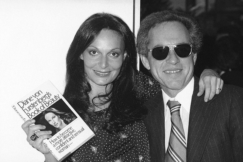 Former Princess Diane von Furstenburg posing with of Simon & Schuster executive Richard Snyder on Feb. 28, 1977 celebrating the publication of her new book on beauty. Snyder, a visionary and imperious executive at Simon & Schuster who presided over the publishers exponential rise over the past half century and helped define an era of growing corporate power, died on Tuesday at his home in Los Angeles at age 90. (AP Photo/RFS, File)