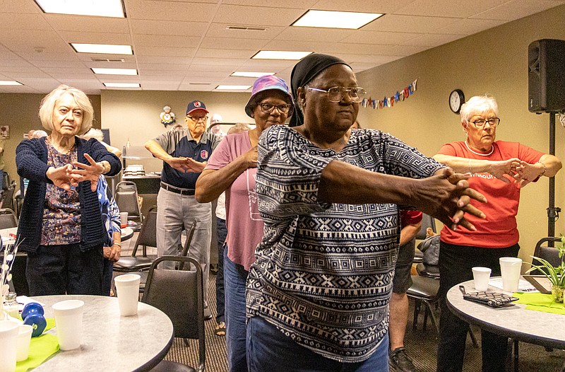 Josh Cobb/News Tribune
Retirees gathered Thursday at the West Point Senior Center for AARP Summer Fest, the quarterly Jefferson City AARP recruitment meeting, and to hear from various recreation agencies about staying active with age. From left, Toni Amos, Lawrence Ulm, Florence Vaughan, Sheree Pigford and Ann Lairmore do Tai Chi with a local Tai Chi instructor during AARP Summer Fest.