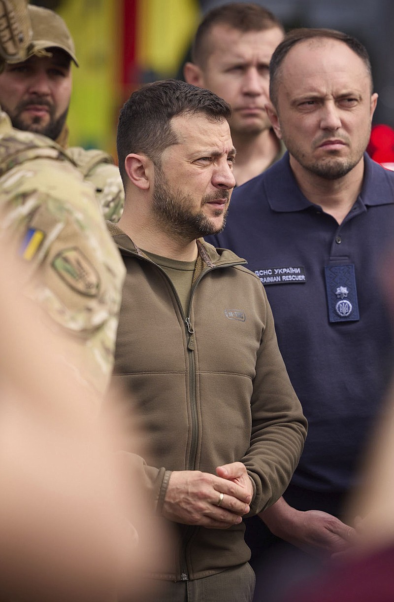 In this photo provided by the Ukrainian Presidential Press Office, Ukrainian President Volodymyr Zelenskyy visits the flooding hit areas in Kherson, Ukraine, Thursday, June 8, 2023. (Ukrainian Presidential Press Office via AP)