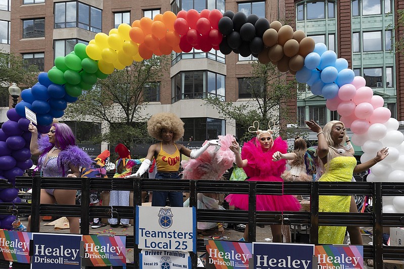 Performer dance on a float during the Pride parade, Saturday, June 10, 2023, in Boston. The biggest Pride parade in New England returned on Saturday after a three-year hiatus, with a fresh focus on social justice and inclusion rather than corporate backing. (AP Photo/Michael Dwyer)