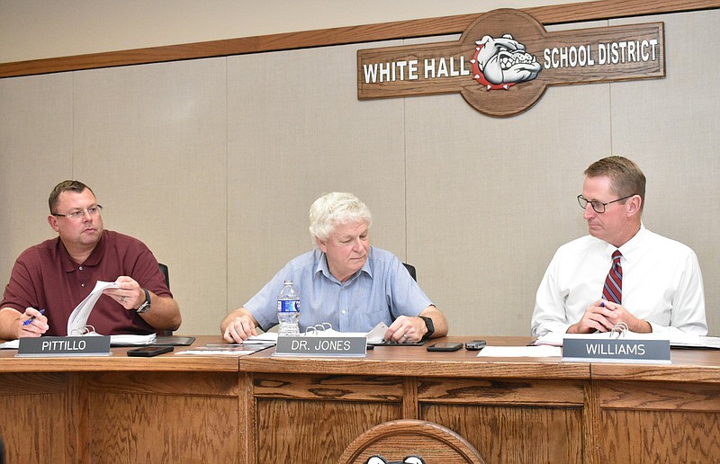 White Hall School District Superintendent Gary Williams, right, makes comments as board President Dr. Raymond Jones, center, and board member Scott Pittillo listen Tuesday. (Pine Bluff Commercial/I.C. Murrell)