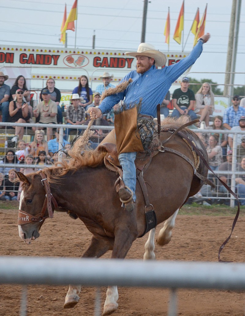Graham Thomas/Herald-Leader
Blane Stacy competes in Saddle Bronc at the 65th annual Siloam Springs Rodeo.