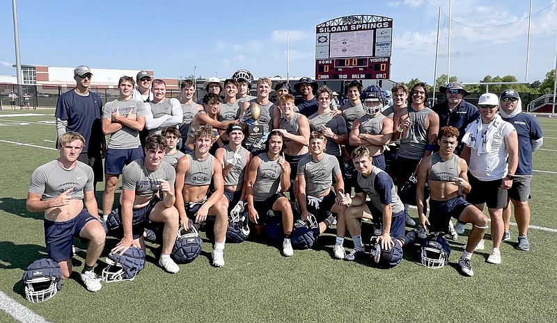 The Greenwood Bulldogs post with the championship trophy after winning the State Line Shootout 7-on-7 tournament in Siloam Springs on Saturday. 
(NWA Democrat-Gazette/Graham Thomas)