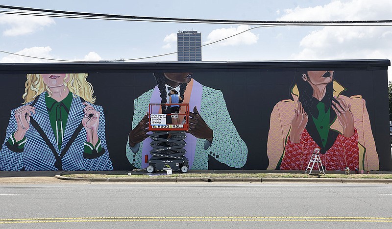 Mural artist Lisa Krannichfeld works on her mural on a building along Chester Street on Thursday, June 15, 2023, in Little Rock. 
(Arkansas Democrat-Gazette/Thomas Metthe)